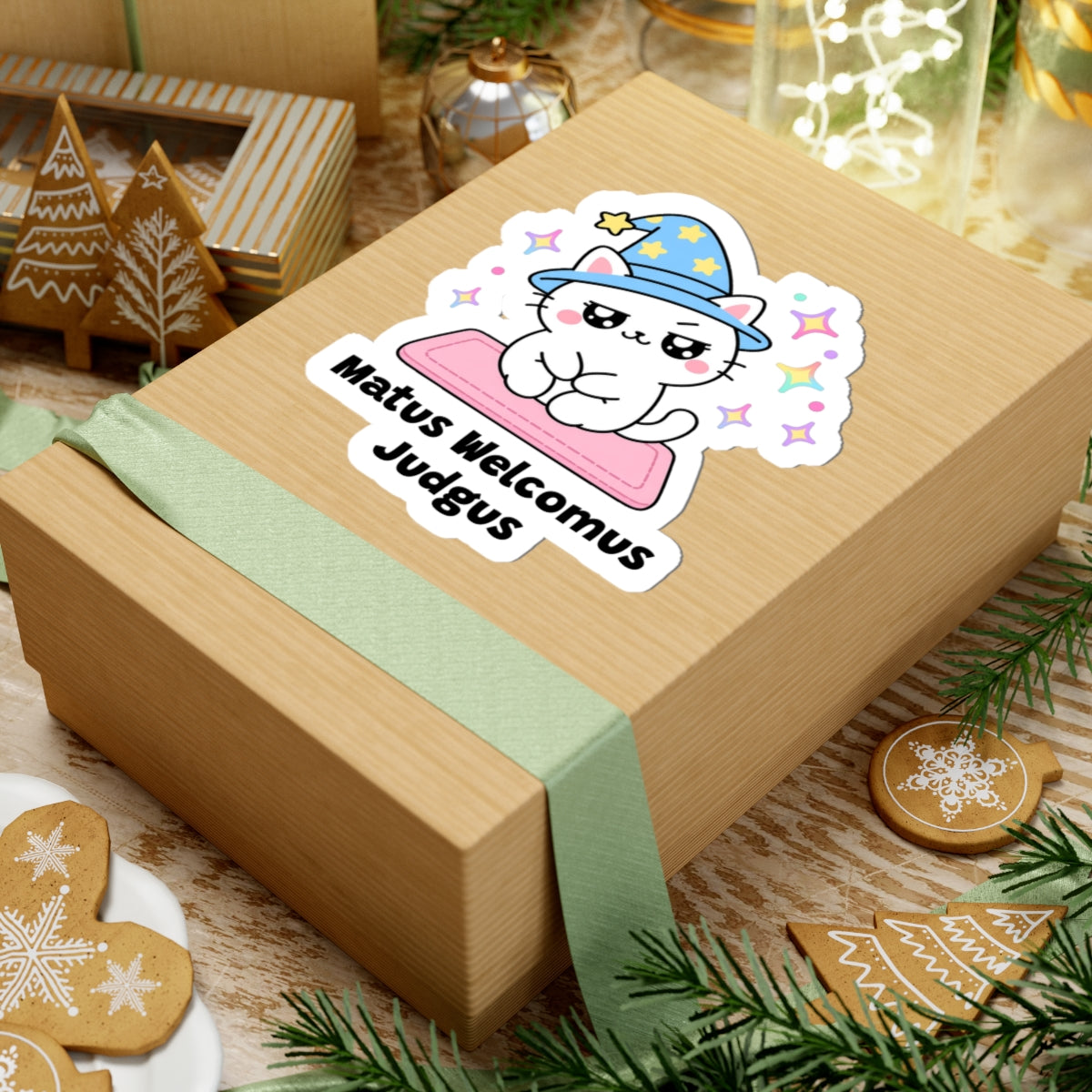 Matus Welcomus Judgus wizard cat sticker on a kraft gift box with a green ribbon and holiday cookies