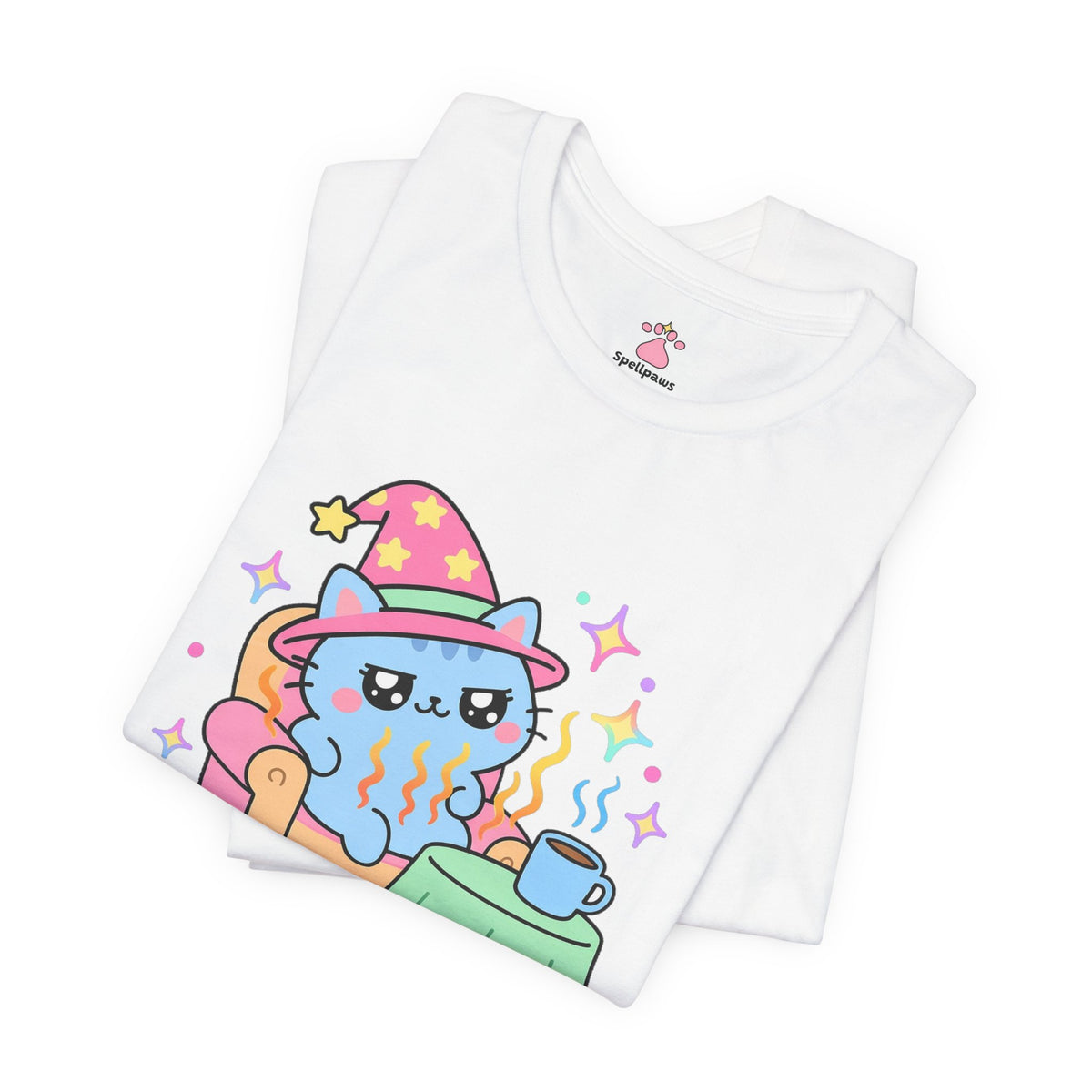 Folded white Chairus Warmus Stealus T-shirt showing a close-up of the blue wizard cat in a pink hat lounging in a warm orange armchair beside a coffee mug