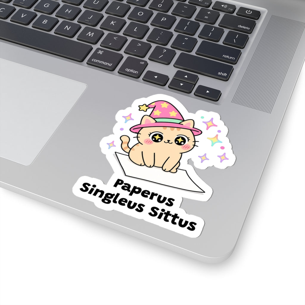 Paperus Singleus Sittus wizard cat sticker stuck on a silver laptop next to the keyboard