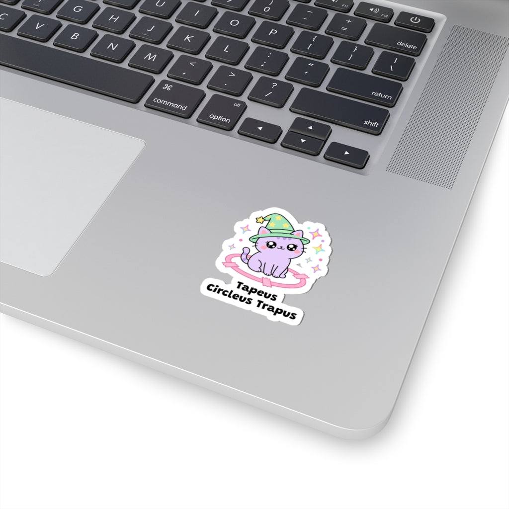 Tapeus Circleus Trapus wizard cat sticker stuck on a silver laptop next to the keyboard