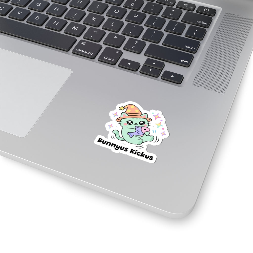 Bunnyus Kickus wizard cat sticker stuck on a silver laptop next to the keyboard