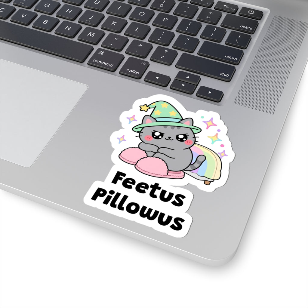 Feetus Pillowus wizard cat sticker stuck on a silver laptop next to the keyboard