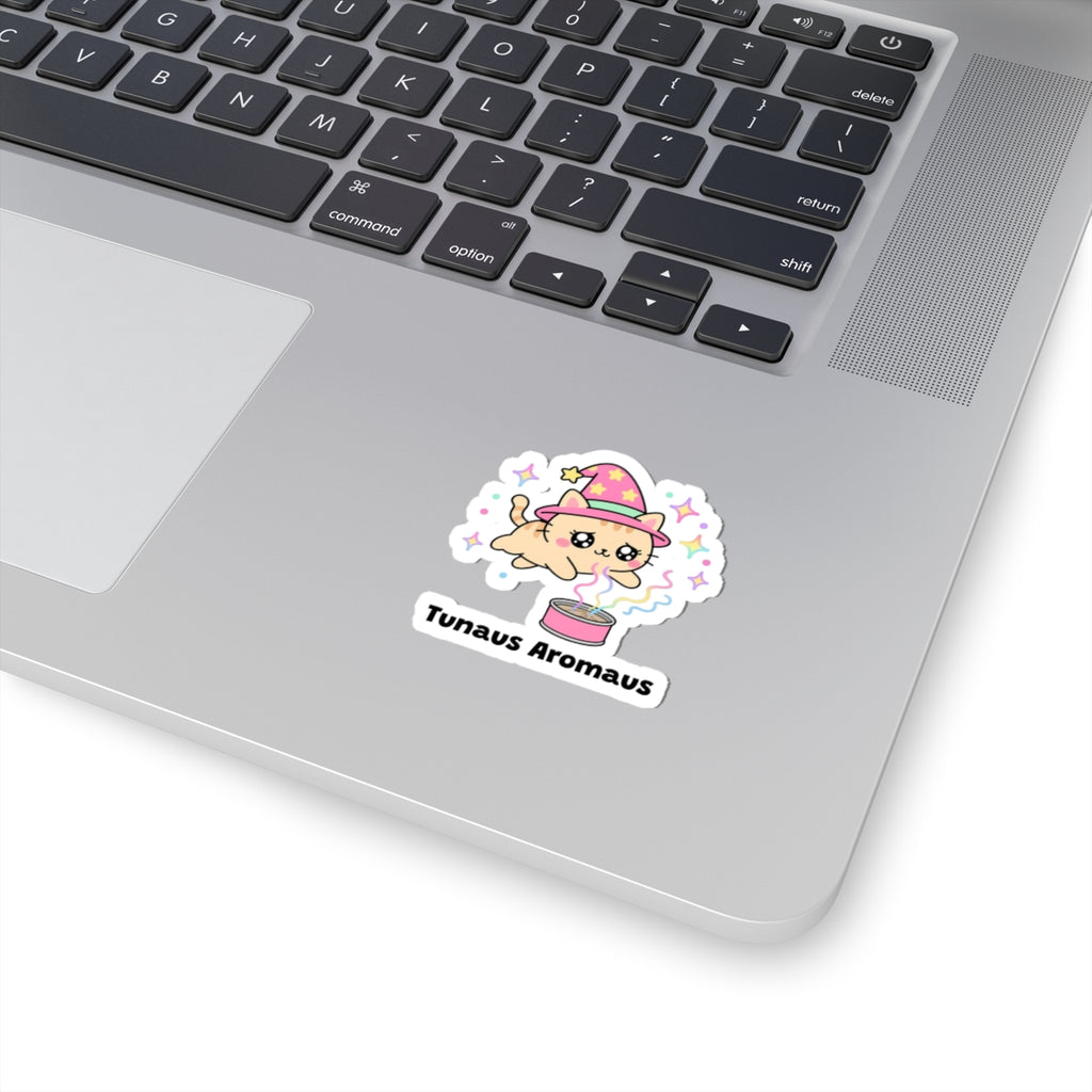 Tunaus Aromaus wizard cat sticker stuck on a silver laptop next to the keyboard