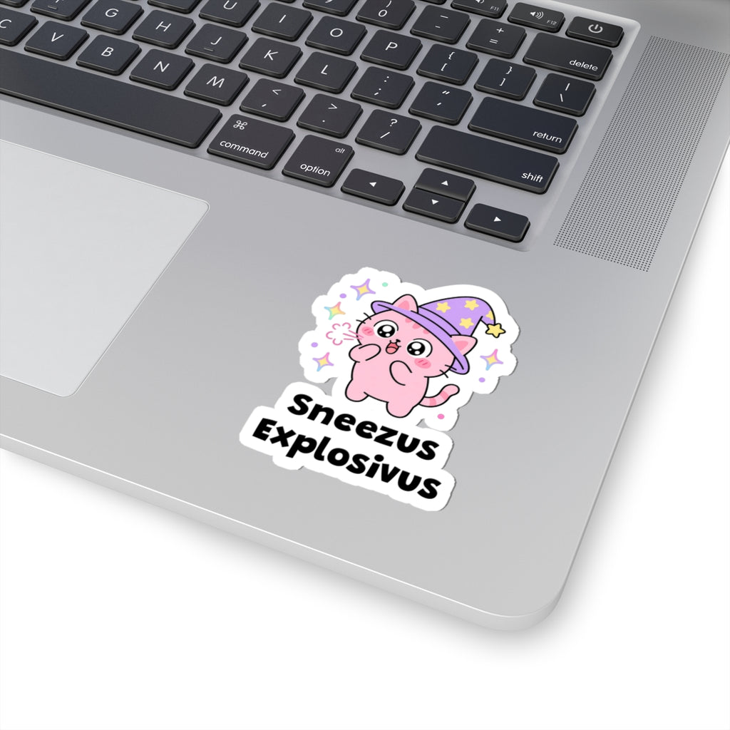 Sneezus Explosivus wizard cat sticker stuck on a silver laptop next to the keyboard