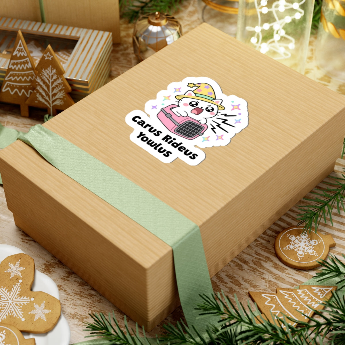 Carus Rideus Yowlus wizard cat sticker on a kraft gift box with a green ribbon and holiday cookies