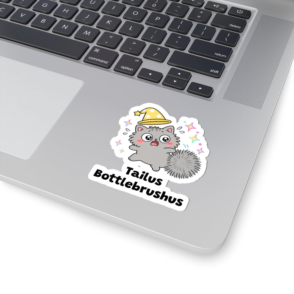Tailus Bottlebrushus wizard cat sticker stuck on a silver laptop next to the keyboard