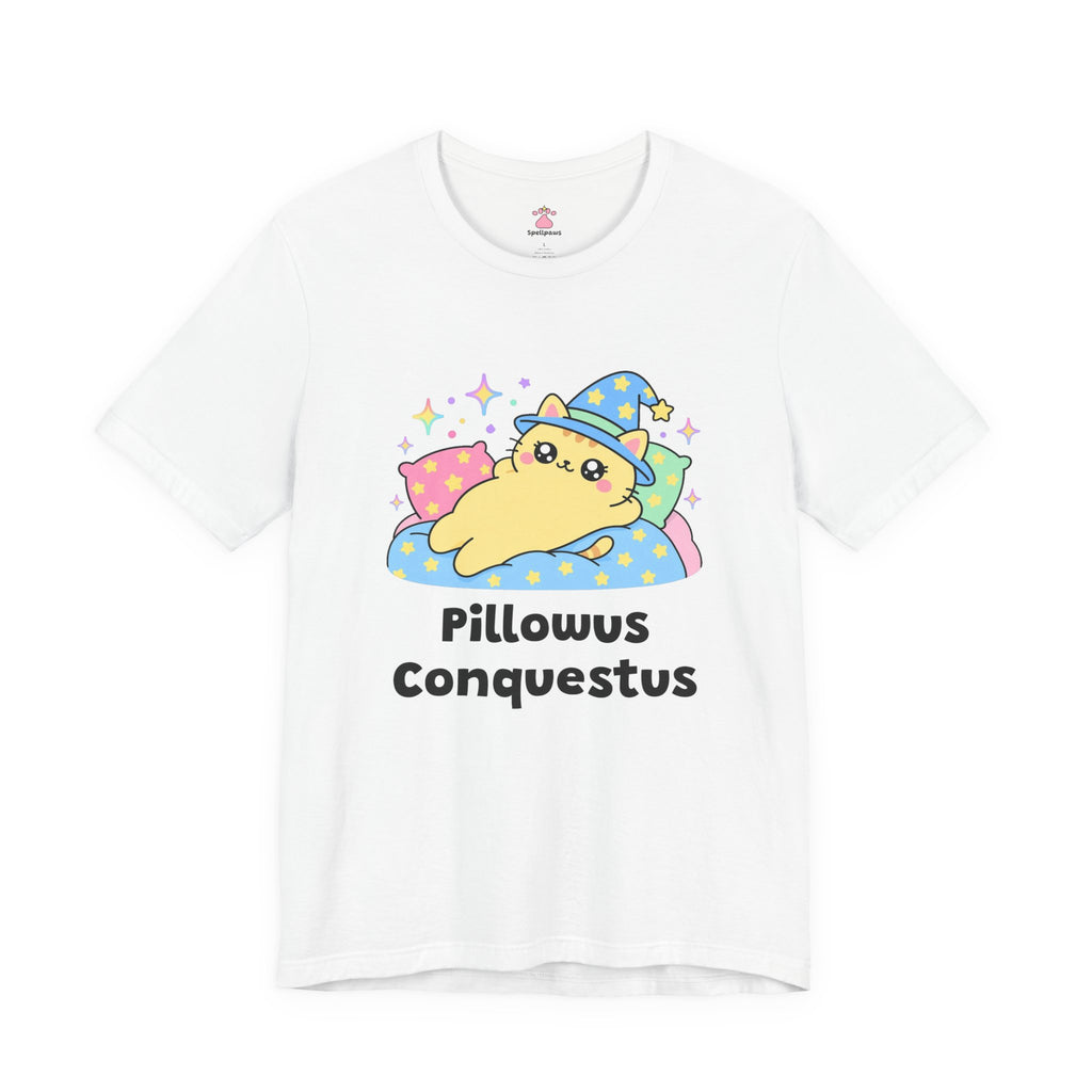 White Pillowus Conquestus wizard cat T-shirt, front view: yellow wizard cat in a blue hat sprawled across a pile of pillows on a starry blanket, with "Pillowus Conquestus" printed below