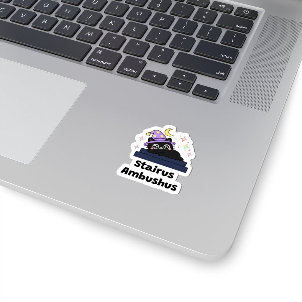 Stairus Ambushus wizard cat sticker stuck on a silver laptop next to the keyboard
