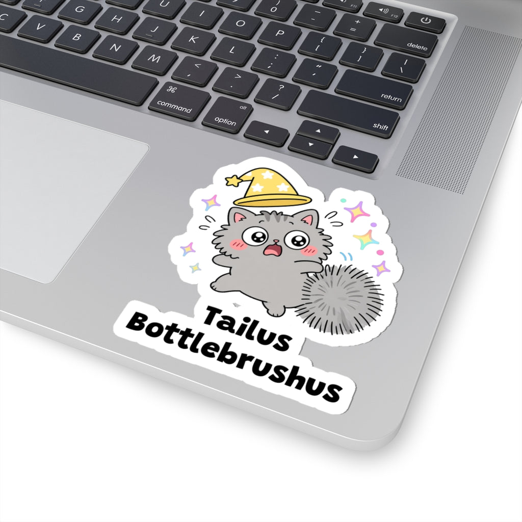 Tailus Bottlebrushus wizard cat sticker stuck on a silver laptop next to the keyboard