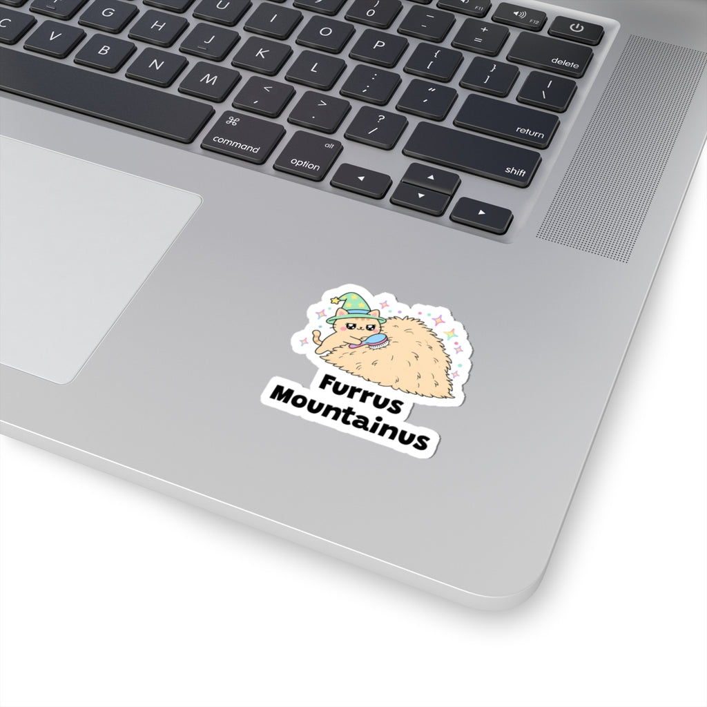Furrus Mountainus wizard cat sticker stuck on a silver laptop next to the keyboard