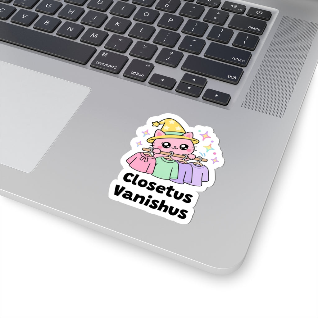 Closetus Vanishus wizard cat sticker stuck on a silver laptop next to the keyboard