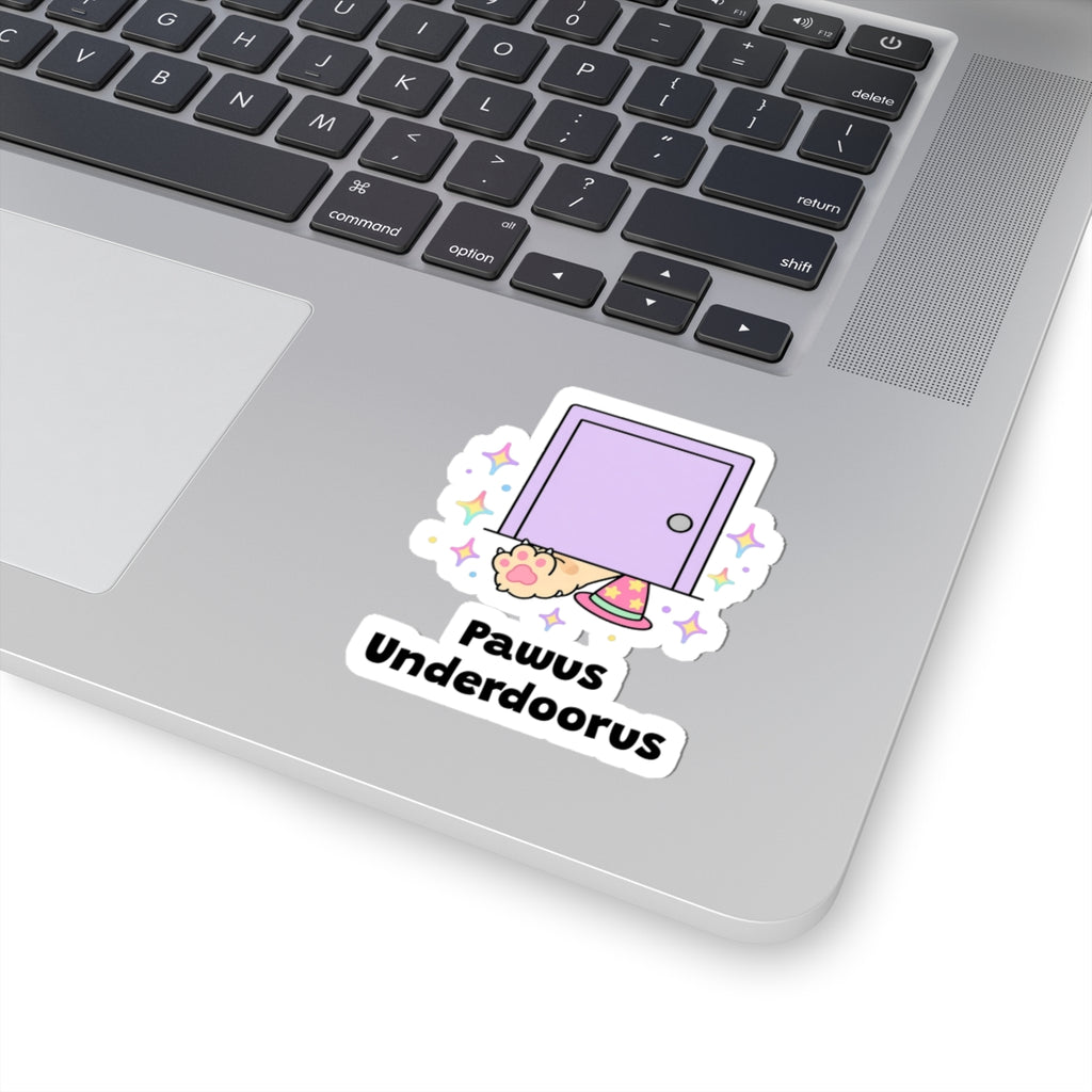 Pawus Underdoorus wizard cat sticker stuck on a silver laptop next to the keyboard