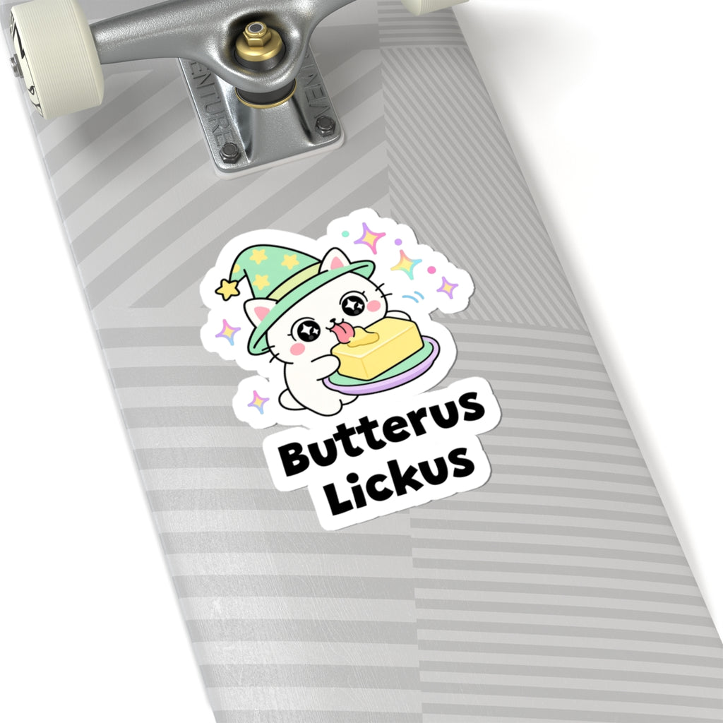 Butterus Lickus wizard cat sticker on a grey skateboard deck near the truck