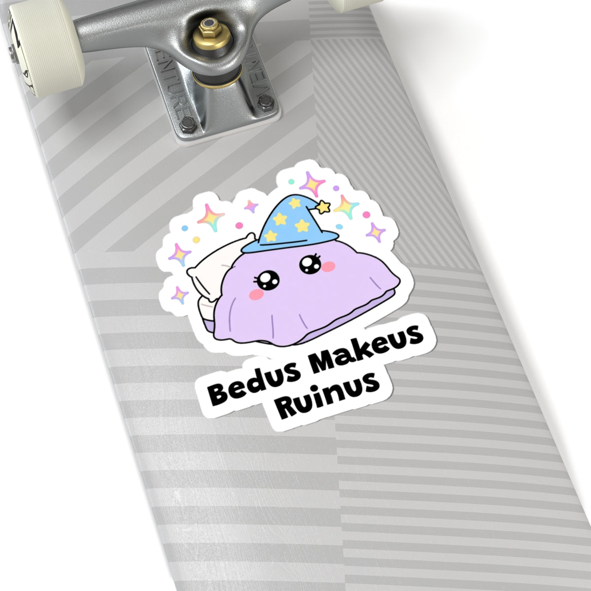Bedus Makeus Ruinus wizard cat sticker on a grey skateboard deck near the truck
