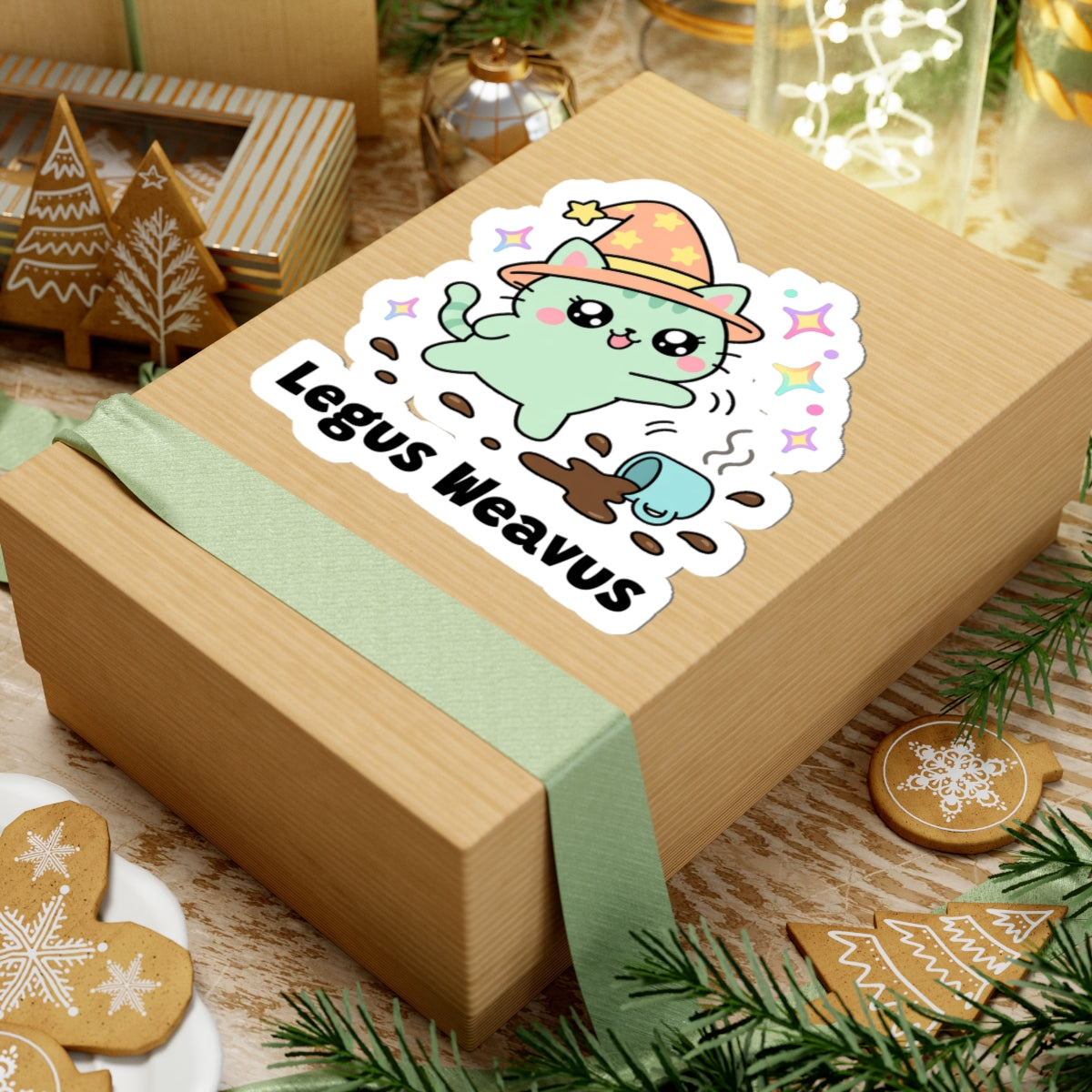 Legus Weavus wizard cat sticker on a kraft gift box with a green ribbon and holiday cookies