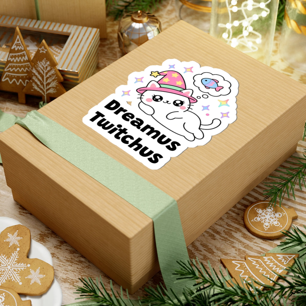 Dreamus Twitchus wizard cat sticker on a kraft gift box with a green ribbon and holiday cookies