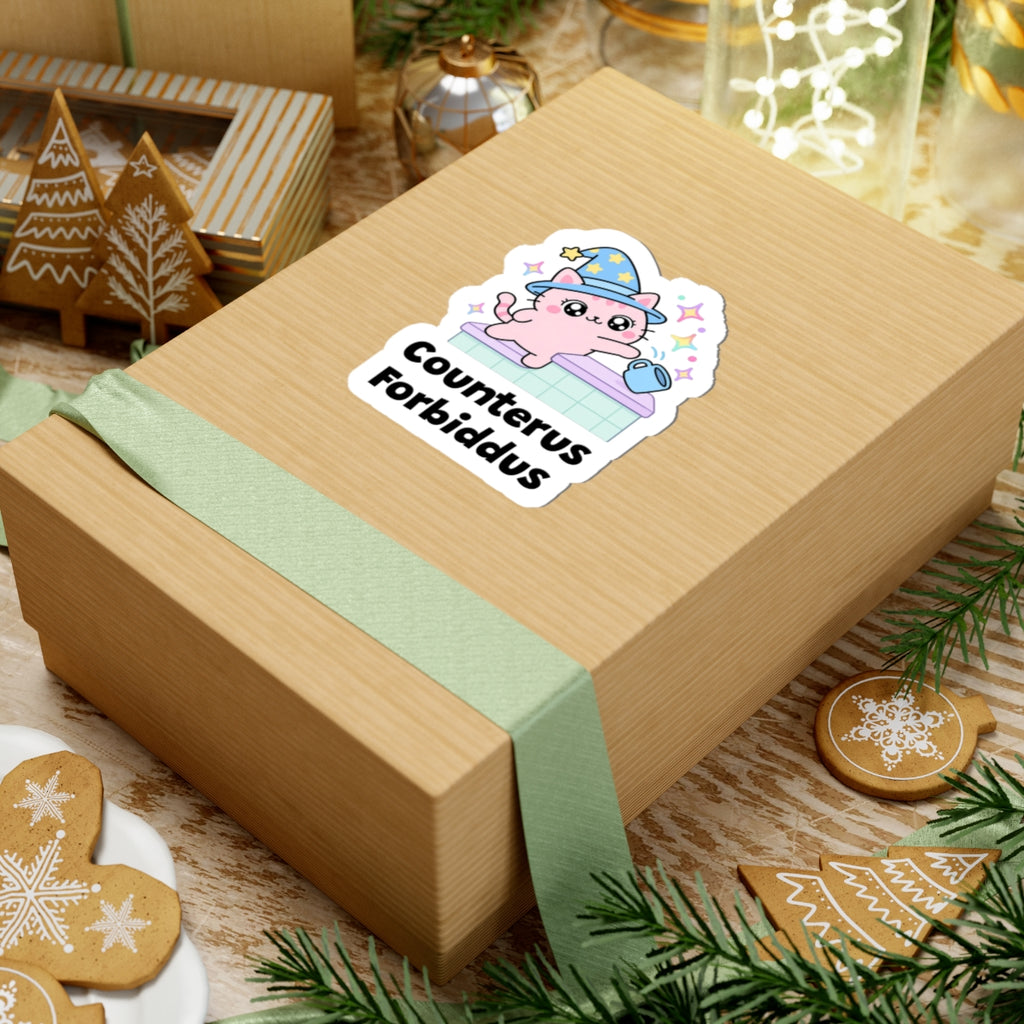 Counterus Forbiddus wizard cat sticker on a kraft gift box with a green ribbon and holiday cookies
