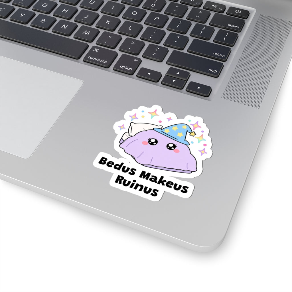 Bedus Makeus Ruinus wizard cat sticker stuck on a silver laptop next to the keyboard