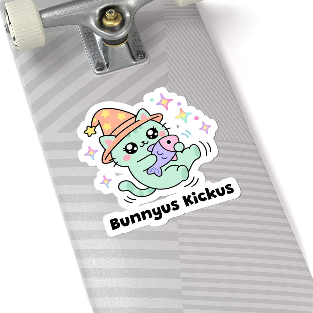 Bunnyus Kickus wizard cat sticker on a grey skateboard deck near the truck