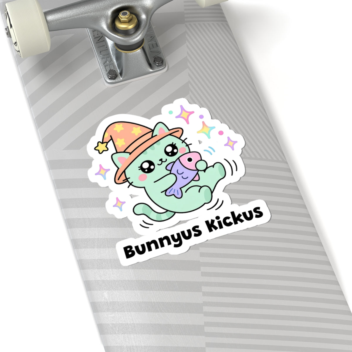 Bunnyus Kickus wizard cat sticker on a grey skateboard deck near the truck