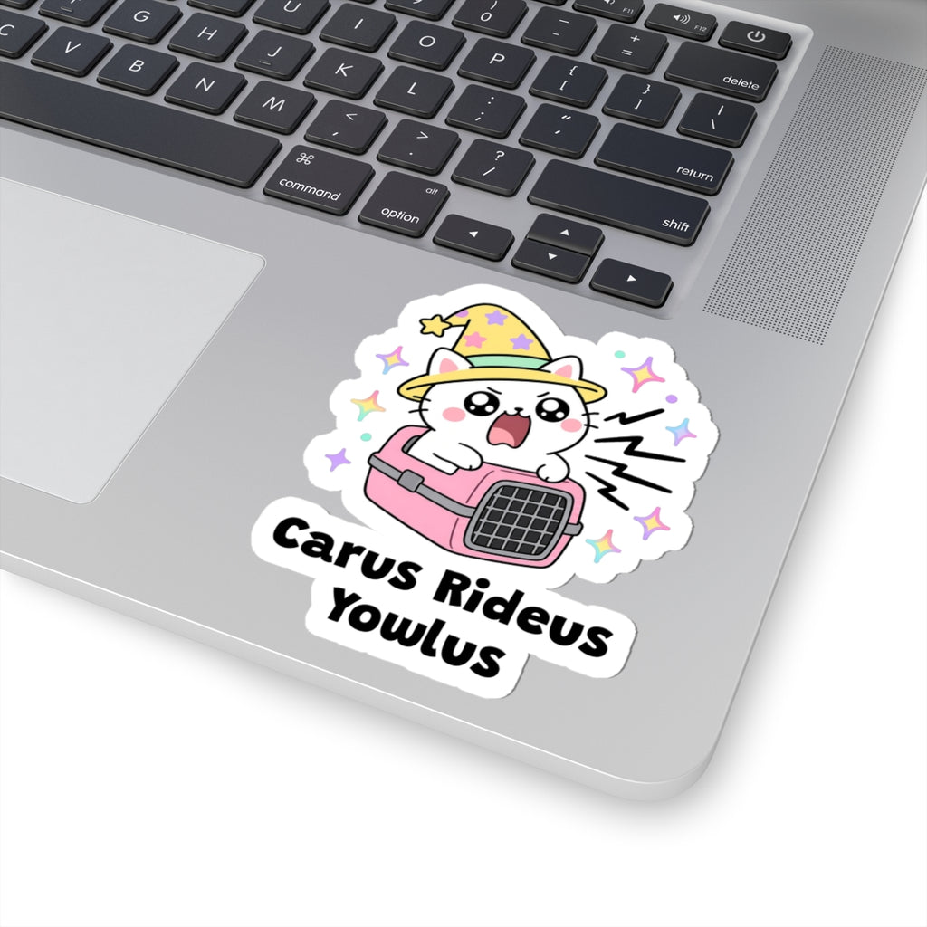 Carus Rideus Yowlus wizard cat sticker stuck on a silver laptop next to the keyboard