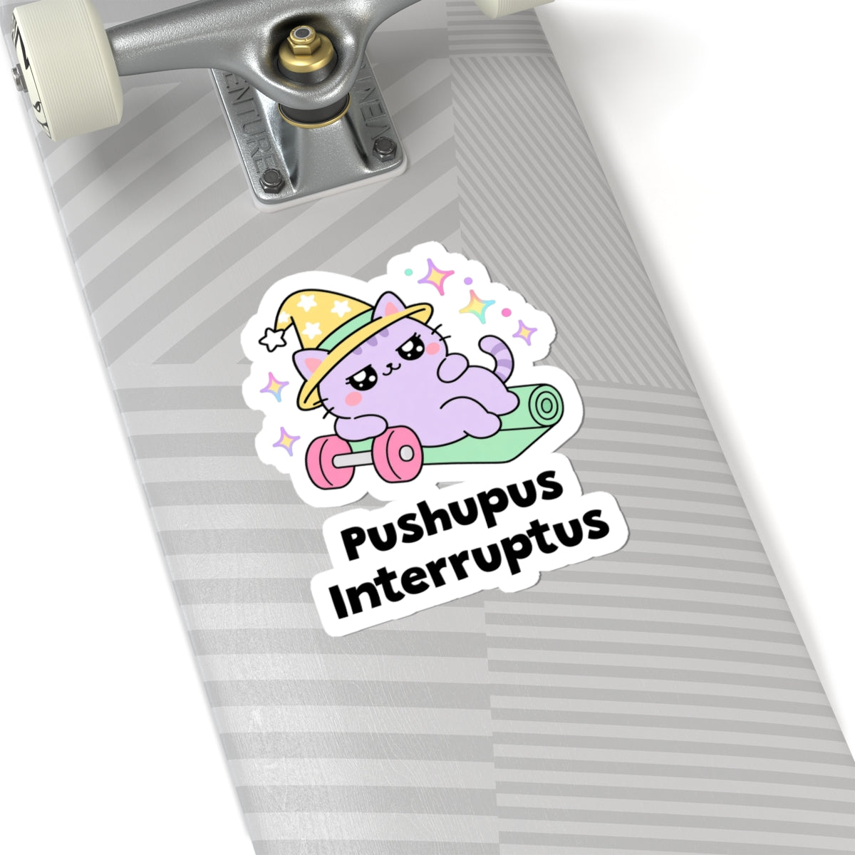 Pushupus Interruptus wizard cat sticker on a grey skateboard deck near the truck
