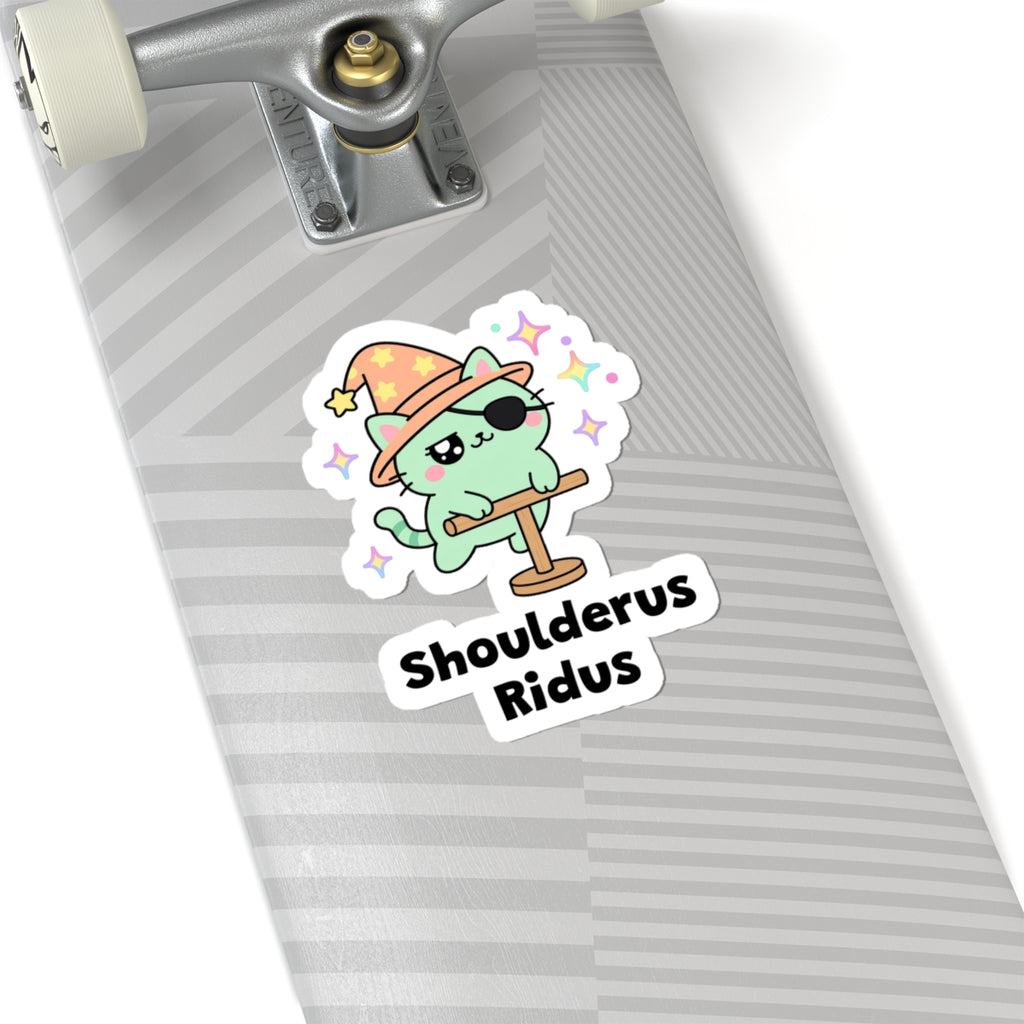 Shoulderus Ridus wizard cat sticker on a grey skateboard deck near the truck