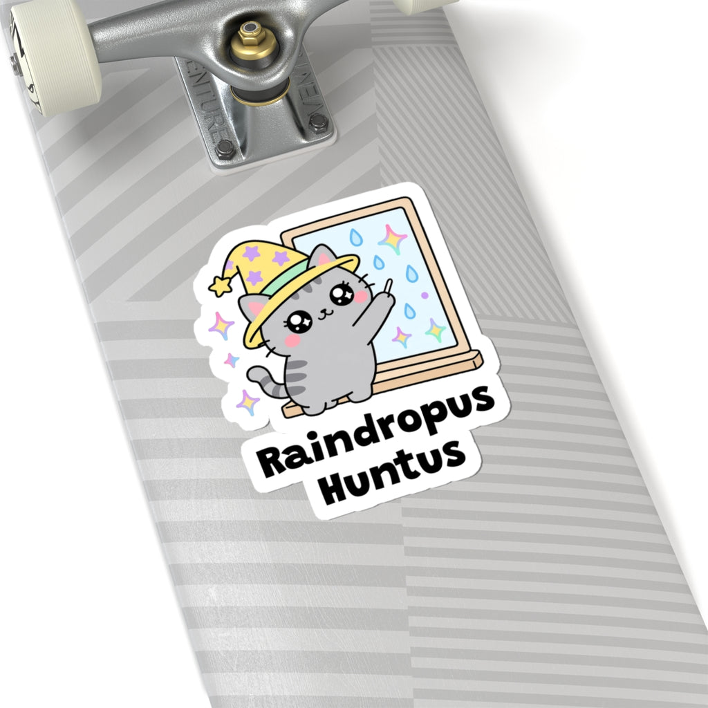 Raindropus Huntus wizard cat sticker on a grey skateboard deck near the truck