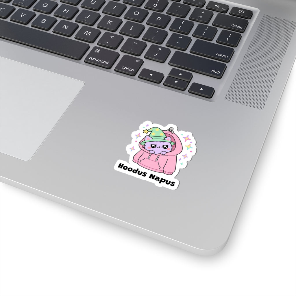 Hoodus Napus wizard cat sticker stuck on a silver laptop next to the keyboard