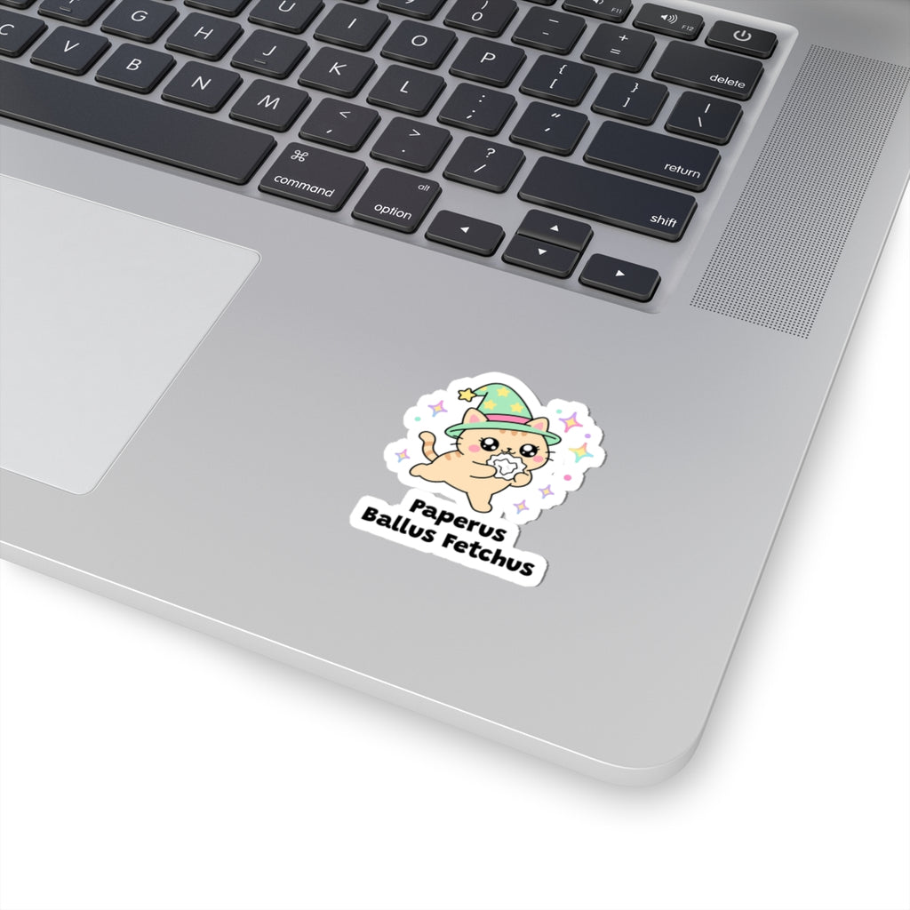 Paperus Ballus Fetchus wizard cat sticker stuck on a silver laptop next to the keyboard