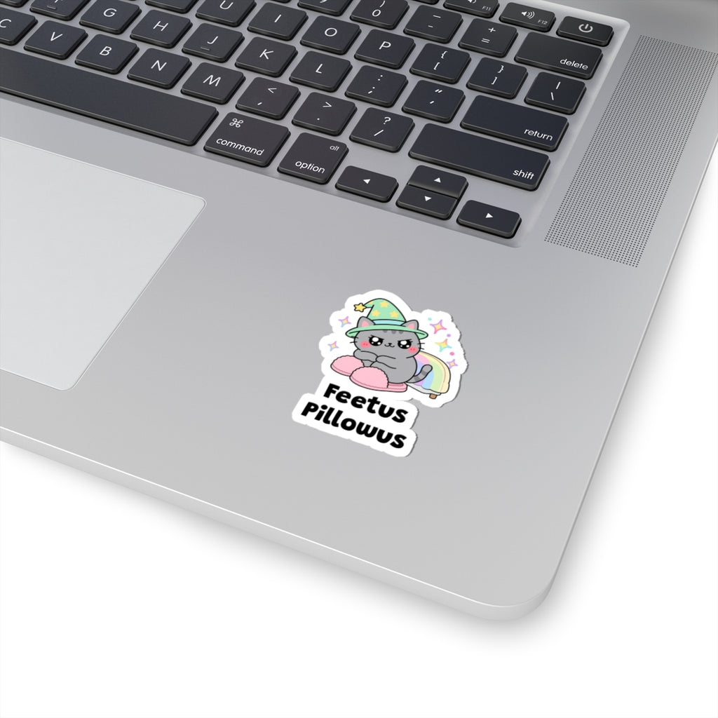 Feetus Pillowus wizard cat sticker stuck on a silver laptop next to the keyboard