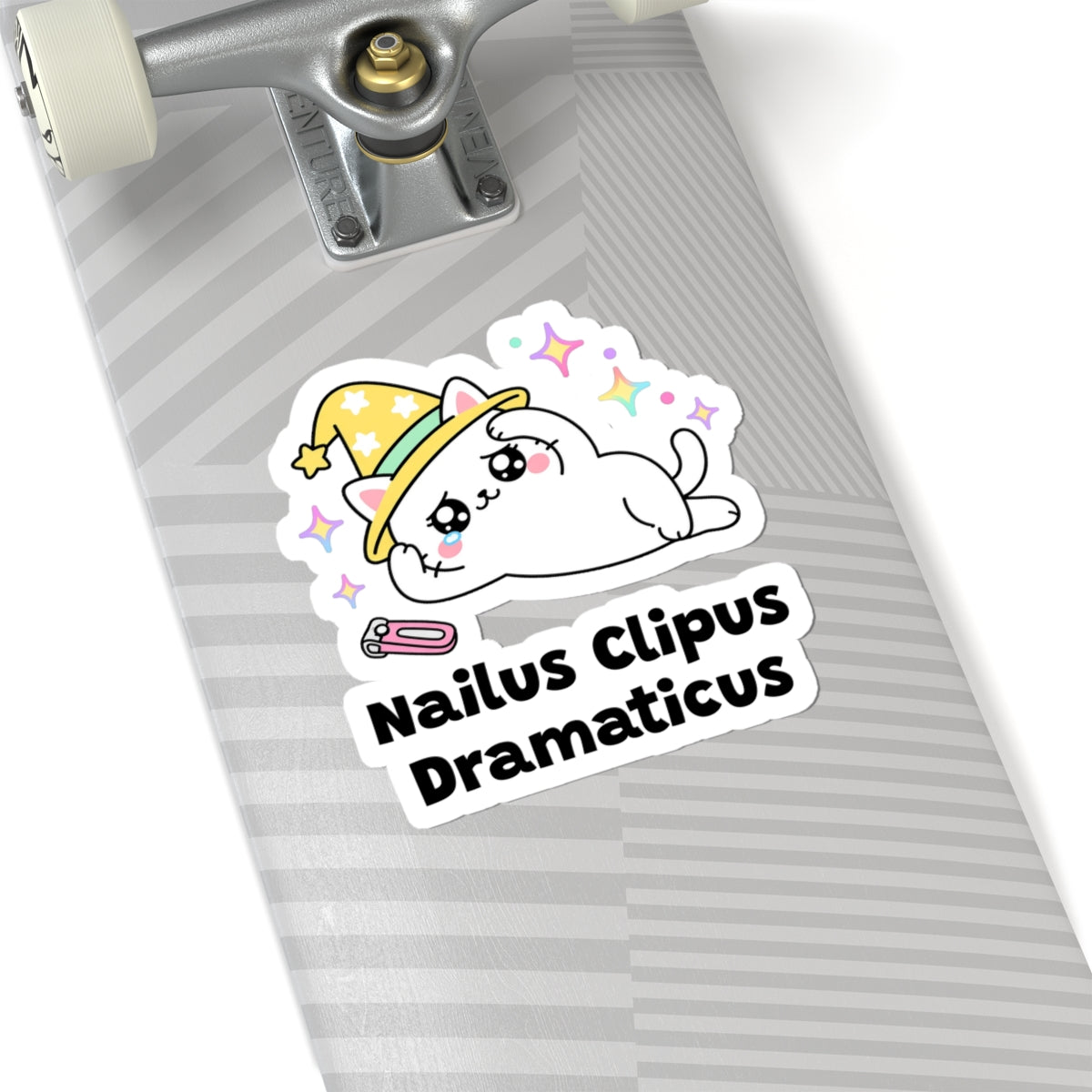 Nailus Clipus Dramaticus wizard cat sticker on a grey skateboard deck near the truck