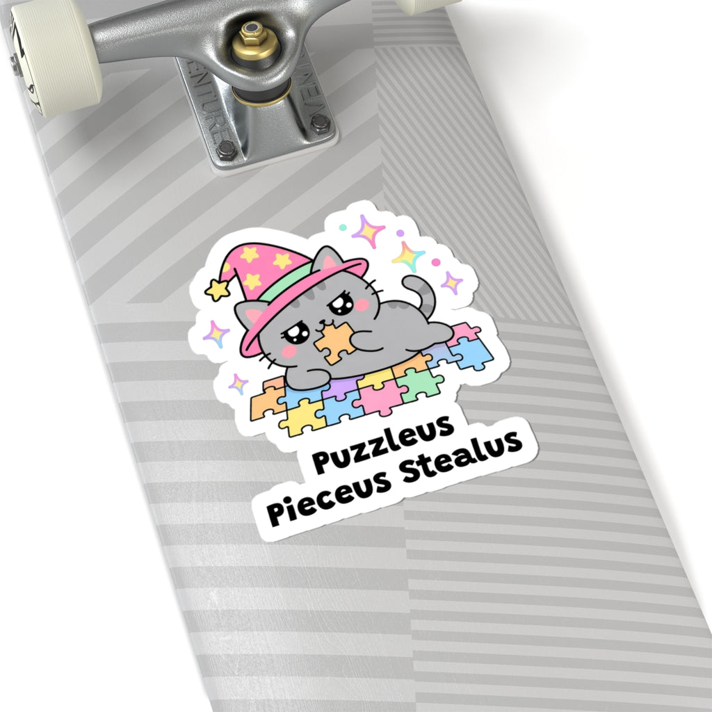 Puzzleus Pieceus Stealus wizard cat sticker on a grey skateboard deck near the truck