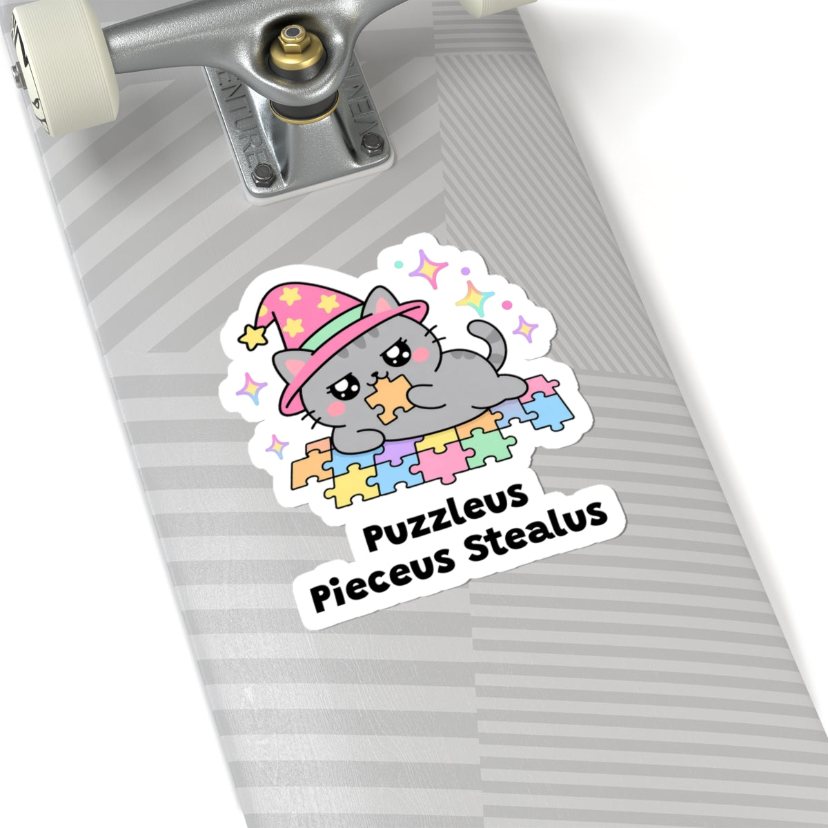 Puzzleus Pieceus Stealus wizard cat sticker on a grey skateboard deck near the truck