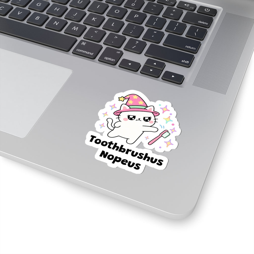 Toothbrushus Nopeus wizard cat sticker stuck on a silver laptop next to the keyboard