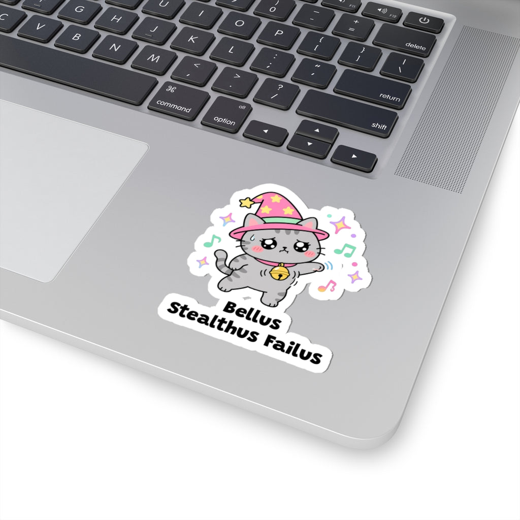 Bellus Stealthus Failus wizard cat sticker stuck on a silver laptop next to the keyboard