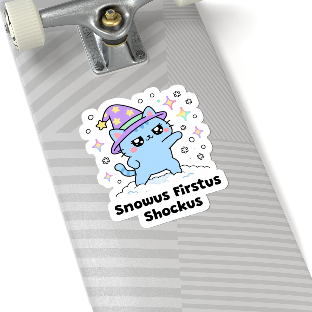 Snowus Firstus Shockus wizard cat sticker on a grey skateboard deck near the truck
