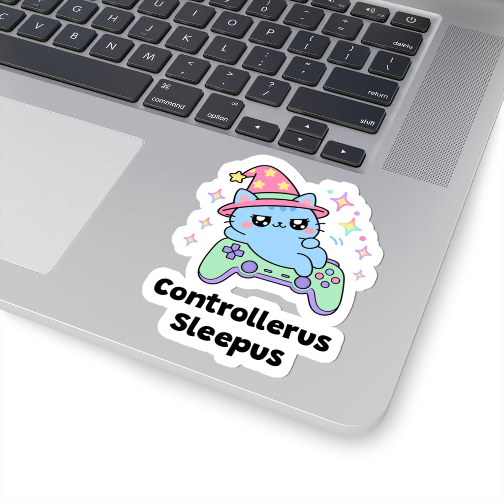 Controllerus Sleepus wizard cat sticker stuck on a silver laptop next to the keyboard